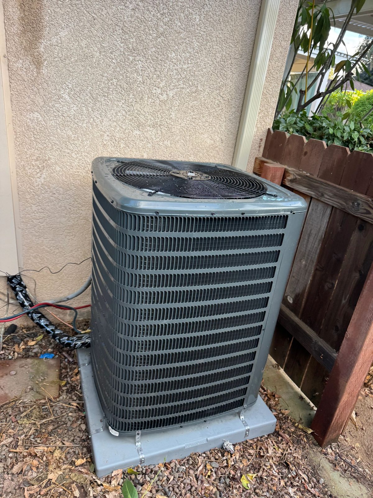 Outdoor 2.5 ton Goodman heat pump condenser unit on concrete pad
