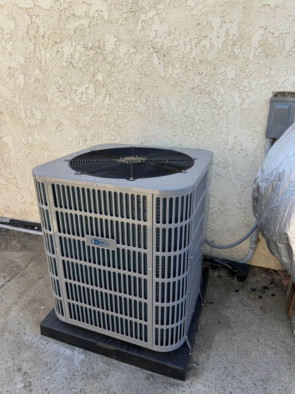Technician installing a new 3-ton heat pump outdoor unit