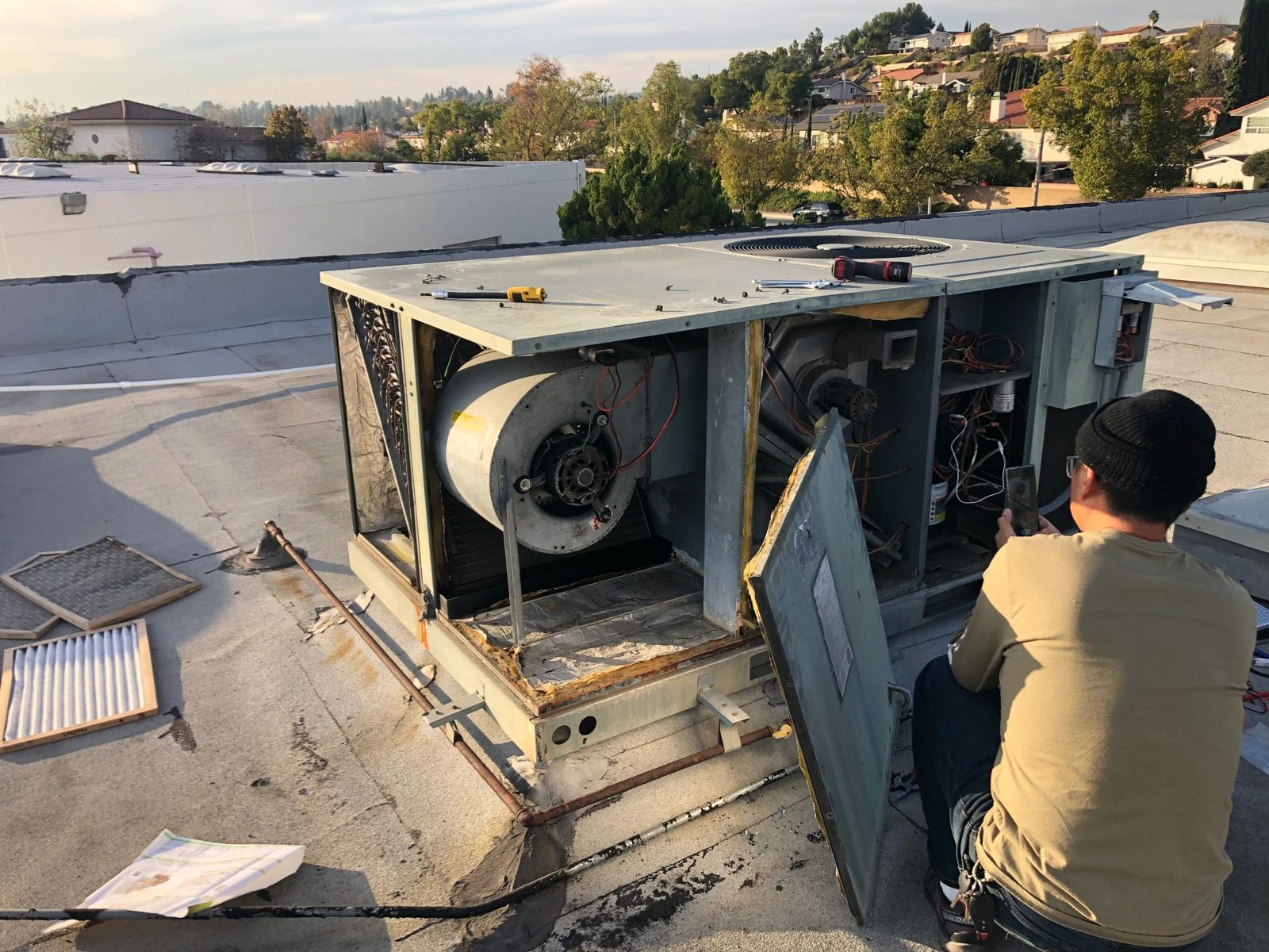 Technician replacing a blower wheel in a residential furnace