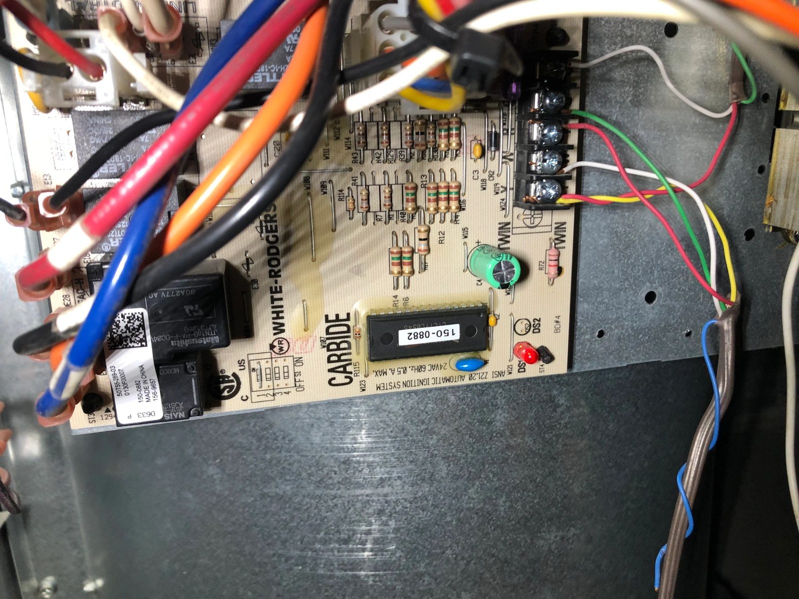 Technician replacing circuit board in Goodman furnace