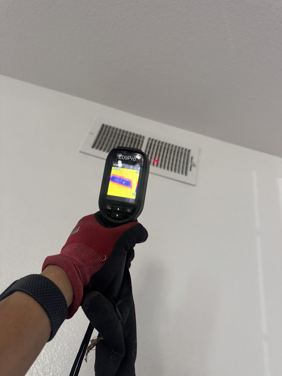 Thermal camera checking ceiling air vents, HVAC scale hoses tank outdoors, manifold gauges on ground by unit during Eastvale repair