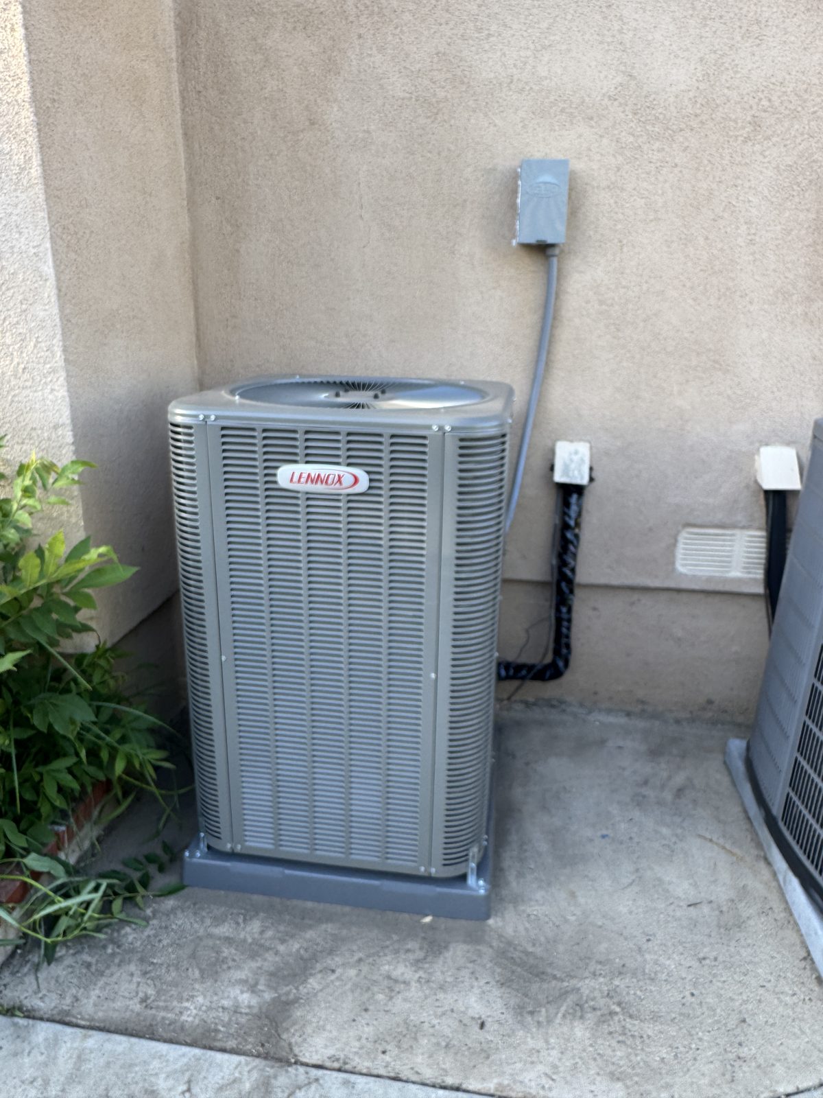 Outdoor Lennox HVAC condenser by wall and attic furnace with ducts during West Covina repair