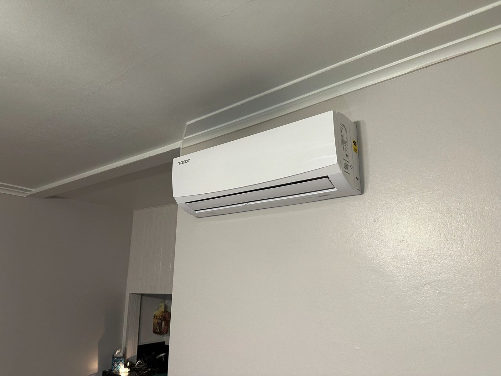 Technicians installing multiple mini-split indoor units on a residential wall