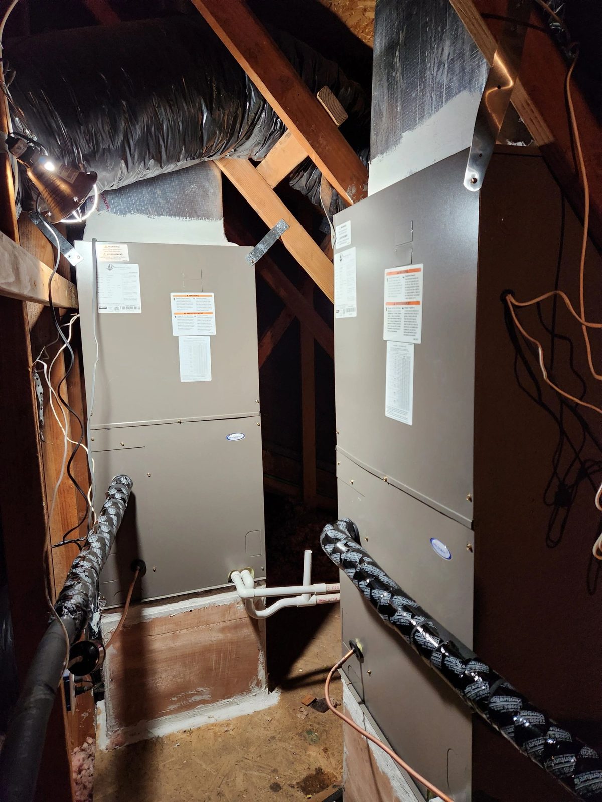 Two new 4-ton heat pump systems installed side by side on a residential rooftop