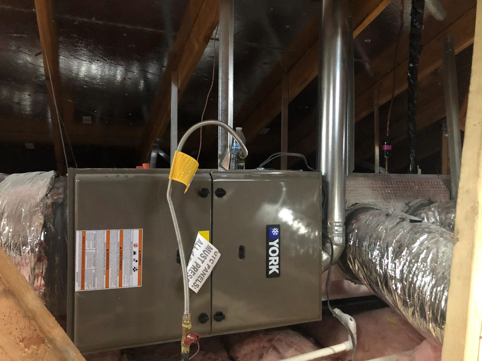Technicians completing new YORK HVAC system installation