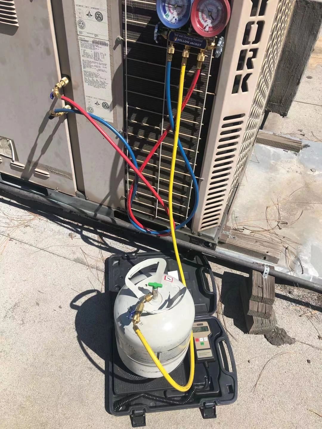 Technician retrofitting HVAC system with R407C refrigerant