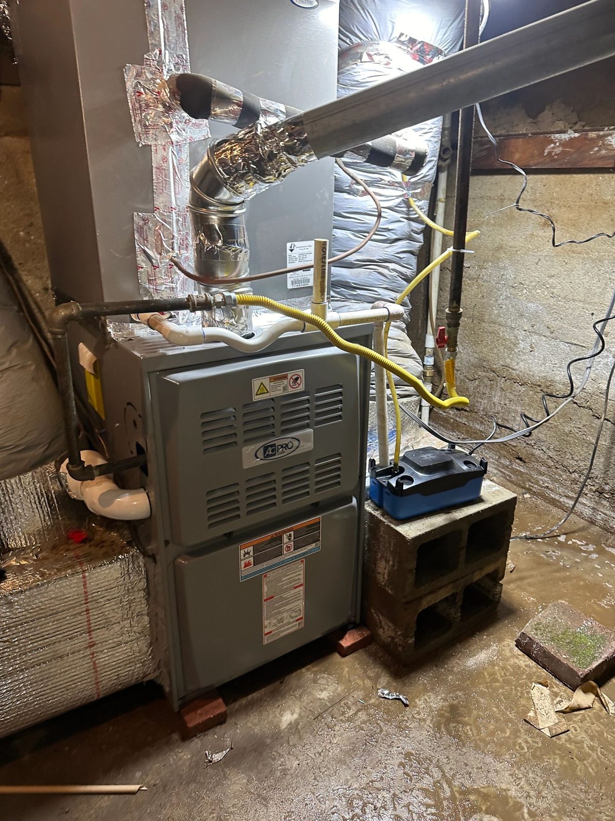 Technician installing new 5-ton furnace in basement